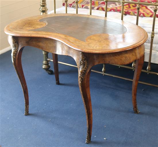 A Victorian walnut and kingwood banded kidney shaped bureau plat, W.122cm